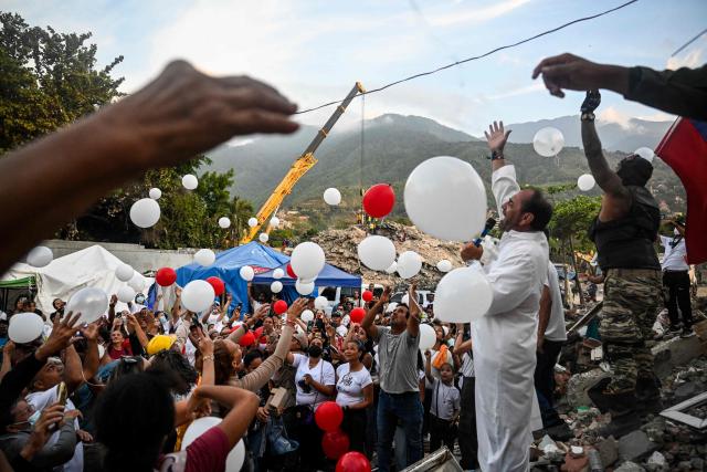 A priest holds a mass with residents and relatives of the earthquake victims from the state-run OPP housing blocks two months after the 7.2 and 7.5-magnitude earthquakes in La Guaira, Venezuela on August 24, 2026. The magnitude 7.2 and 7.5 tremors on June 24, 2026, devastated the coastal state of La Guaira, where at least 190 buildings fell apart. Venezuela's interim government reported 6,509 deaths on August 24, 2026, exactly two months after the twin earthquakes. (Photo by Maryorin Mendez / AFP)