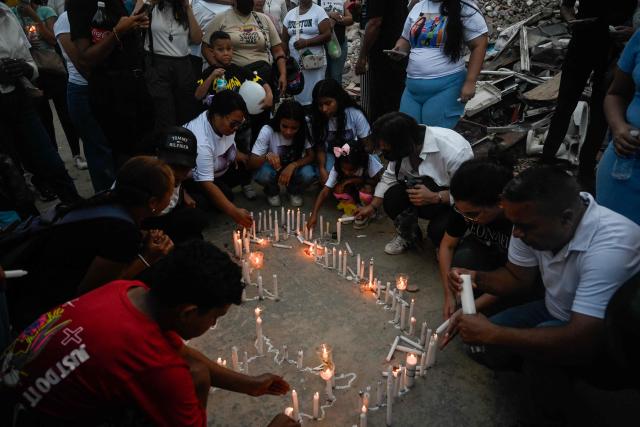 People light candles next to a collapsed building from the state-run OPP housing blocks two months after the 7.2 and 7.5-magnitude earthquakes in La Guaira, Venezuela on August 24, 2026. The magnitude 7.2 and 7.5 tremors on June 24, 2026, devastated the coastal state of La Guaira, where at least 190 buildings fell apart. Venezuela's interim government reported 6,509 deaths on August 24, 2026, exactly two months after the twin earthquakes. (Photo by Maryorin Mendez / AFP)