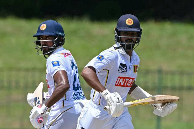 Sri Lanka's Pasindu Sooriyabandara (R) and Kamindu Mendis run between the wickets during the third day of the second Test cricket match between Sri Lanka and India at the Sinhalese Sports Club Ground in Colombo on August 25, 2026. (Photo by Ishara S. KODIKARA / AFP)