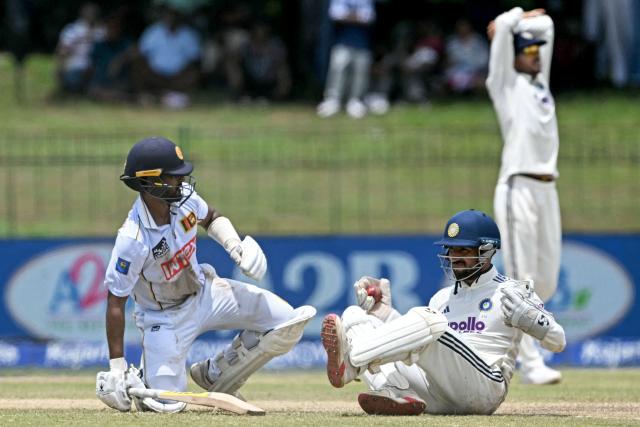 Sri Lanka's Pasindu Sooriyabandara (L) reacts after beating a close run-out as India's Dhruv Jurel slips while fielding during the third day of the second Test cricket match between Sri Lanka and India at the Sinhalese Sports Club Ground in Colombo on August 25, 2026. (Photo by Ishara S. KODIKARA / AFP)