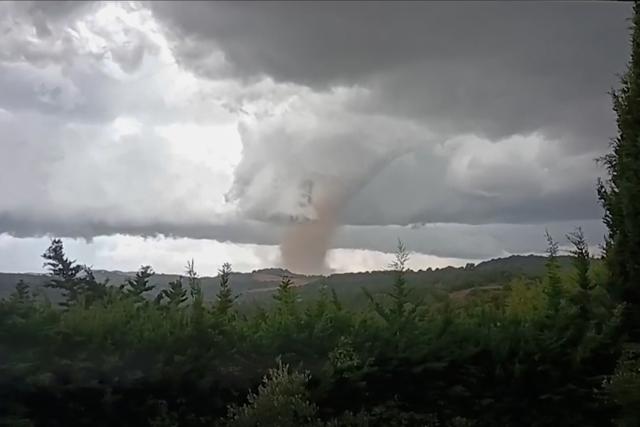 TOPSHOT - This video grab taken from Villefloure, shows a tornado hitting Pomas, southwestern France, on August 24, 2026. A tornado struck the Aude department on August 24 as part of southwestern France remained under an orange storm alert, with several rooftops torn off in the village of Pomas, an AFP photographer at the scene reported. (Photo by Cyrille Kaldor / UGC / AFP / AFP)