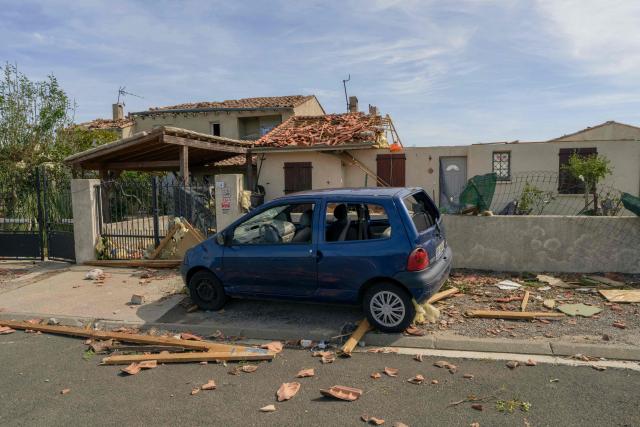 This photograph shows damaged car and houses following a tornado in Pomas, southwestern France on August 25, 2026. A tornado struck the Aude department on August 24, 2026. In the aftermath of a violent tornado, the village of Pomas (Aude) was taking stock of the damage on August 25, 2026: there were 39 people injured, two of whom were in a critical condition, and 300 homes affected, according to the prefecture. (Photo by Idriss Bigou-Gilles / AFP)