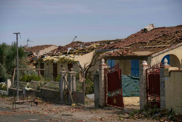 This photograph shows damaged houses following a tornado in Pomas, southwestern France on August 25, 2026. A tornado struck the Aude department on August 24, 2026. In the aftermath of a violent tornado, the village of Pomas (Aude) was taking stock of the damage on August 25, 2026: there were 39 people injured, two of whom were in a critical condition, and 300 homes affected, according to the prefecture. (Photo by Idriss Bigou-Gilles / AFP)
