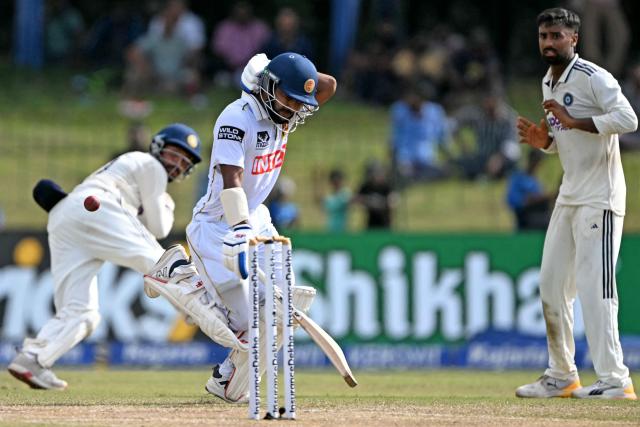 Sri Lanka's Sonal Dinusha (C) runs between the wickets during the third day of the second Test cricket match between Sri Lanka and India at the Sinhalese Sports Club Ground in Colombo on August 25, 2026. (Photo by Ishara S. KODIKARA / AFP)