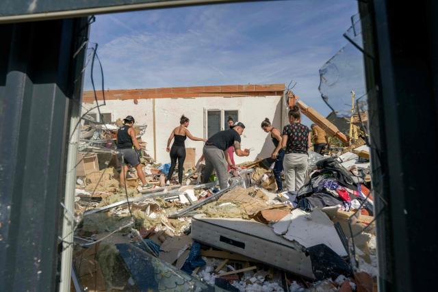 People clean debris of a damaged house following a tornado in Pomas, southwestern France on August 25, 2026. A tornado struck the Aude department on August 24, 2026. In the aftermath of a violent tornado, the village of Pomas (Aude) was taking stock of the damage on August 25, 2026: there were 39 people injured, two of whom were in a critical condition, and 300 homes affected, according to the prefecture. (Photo by Idriss Bigou-Gilles / AFP)