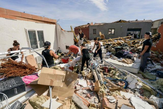 People clean debris of a damaged house following a tornado in Pomas, southwestern France on August 25, 2026. A tornado struck the Aude department on August 24, 2026. In the aftermath of a violent tornado, the village of Pomas (Aude) was taking stock of the damage on August 25, 2026: there were 39 people injured, two of whom were in a critical condition, and 300 homes affected, according to the prefecture. (Photo by Idriss Bigou-Gilles / AFP)