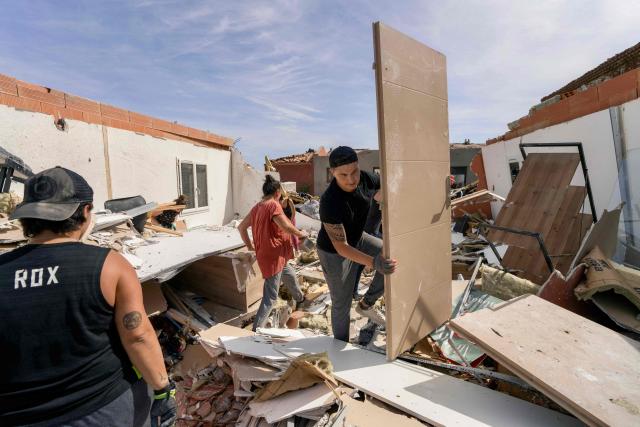 People clean debris of a damaged house following a tornado in Pomas, southwestern France on August 25, 2026. A tornado struck the Aude department on August 24, 2026. In the aftermath of a violent tornado, the village of Pomas (Aude) was taking stock of the damage on August 25, 2026: there were 39 people injured, two of whom were in a critical condition, and 300 homes affected, according to the prefecture. (Photo by Idriss Bigou-Gilles / AFP)