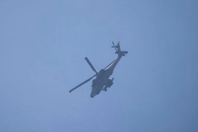 An Israeli Apache helicopter flies over the Marjayoun area in sothern Lebanon on August 25, 2026. Lebanon was drawn into the Middle East war on March 2, when pro-Iran Hezbollah launched rockets towards Israel in response to US-Israeli strikes that killed Iranian supreme leader on February 28, 2026. Despite a November 2024 ceasefire that was supposed to end more than a year of hostilities between Israel and the Iran-backed Hezbollah group, Israel has kept up strikes on Lebanon and has maintained troops in areas in southern Lebanon it deems strategic. (Photo by AFP) / 