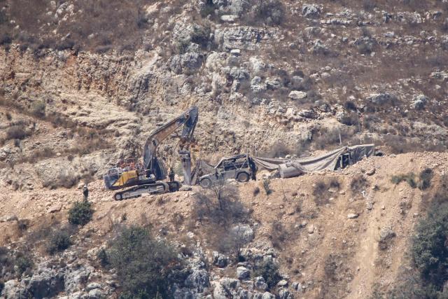 This photograph taken from the southern Lebanese area of Marjayoun shows Israeli bulldozers opening routes in the mountainous area of al Shqif and along the Litani river on August 25, 2026. Lebanon was drawn into the Middle East war on March 2, when pro-Iran Hezbollah launched rockets towards Israel in response to US-Israeli strikes that killed Iranian supreme leader on February 28, 2026. Despite a November 2024 ceasefire that was supposed to end more than a year of hostilities between Israel and the Iran-backed Hezbollah group, Israel has kept up strikes on Lebanon and has maintained troops in areas in southern Lebanon it deems strategic. (Photo by AFP) / 