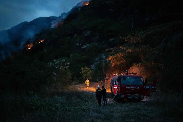 Colombian firefighters battle a wildfire in Coello, Tolima department, Colombia on August 25, 2026. (Photo by ESTEBAN VEGA LA-ROTTA / AFP)