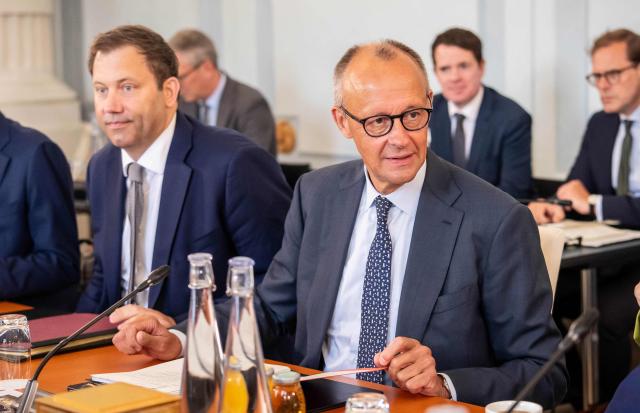 German Chancellor Friedrich Merz and German Finance Minister and Vice Chancellor Lars Klingbeil (L) have taken their seats prior to the start of the second day of a two day retreat meeting of the German cabinet on August 26, 2026 in Neuhardenberg, northeastern Germany. (Photo by Michael Kappeler / POOL / AFP)