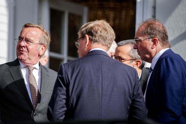 (L-R) German Defence Minister Boris Pistorius, German Foreign Minister Johann Wadephul and German Interior Minister Alexander Dobrindt stand on a terrace during a two day retreat meeting of the German cabinet on August 26, 2026 in Neuhardenberg, northeastern Germany. (Photo by Kay Nietfeld / POOL / AFP)