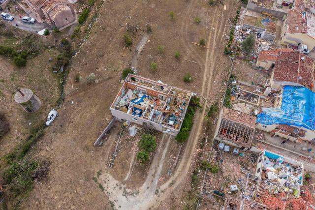This photograph shows an aerial view of houses destroyed after a tornado in Pomas, southwestern France, on August 26, 2025. Amid the rubble, firefighters, residents, and volunteers were hard at work on Augfust 26, 2026, after a tornado of rare intensity swept through, clearing, securing, and protecting more than 300 damaged houses, 102 of which were destroyed, in the village of Pomas in the Aude département. (Photo by Idriss Bigou-Gilles / AFP)