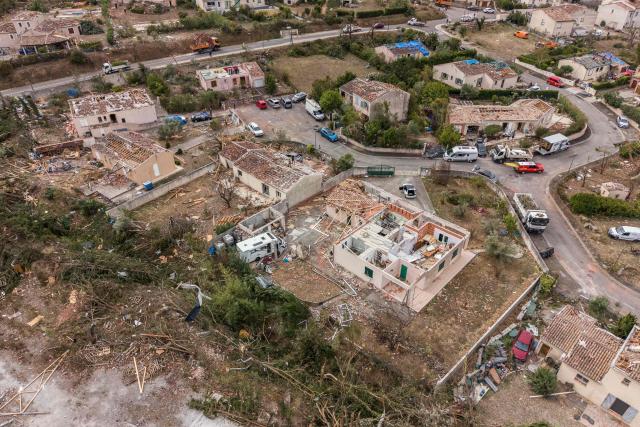 This photograph shows an aerial view of houses destroyed after a tornado in Pomas, southwestern France, on August 26, 2025. Amid the rubble, firefighters, residents, and volunteers were hard at work on Augfust 26, 2026, after a tornado of rare intensity swept through, clearing, securing, and protecting more than 300 damaged houses, 102 of which were destroyed, in the village of Pomas in the Aude département. (Photo by Idriss Bigou-Gilles / AFP)