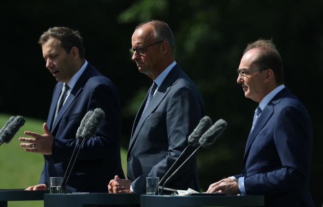 (L-R) German Finance Minister and Vice Chancellor Lars Klingbeil, German Chancellor Friedrich Merz and German Interior Minister Alexander Dobrindt give a press statement in front of Schloss Neuhardenberg palace following a two-day retreat meeting of the German cabinet on August 26, 2026 in Neuhardenberg, northeastern Germany. (Photo by Odd ANDERSEN / AFP)