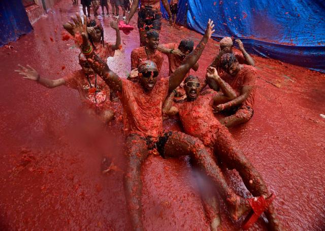 Revellers participate in the "Tomatina" annual food-battle in the Spanish eastern town of Bunol, on August 26, 2026. (Photo by Jose JORDAN / AFP)