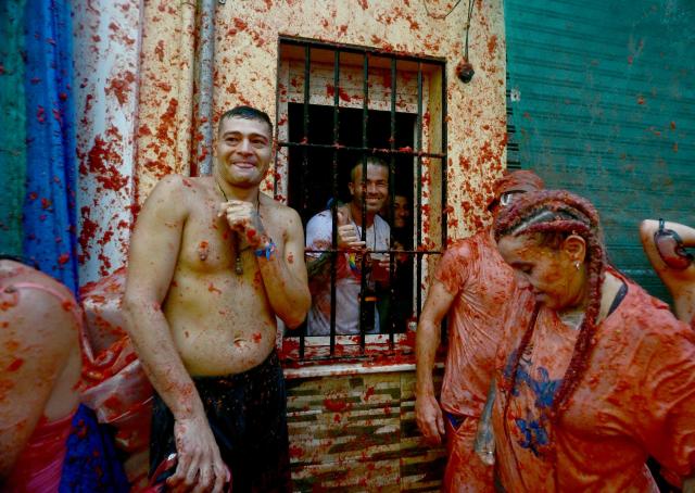 Revellers participate in the "Tomatina" annual food-battle in the Spanish eastern town of Bunol, on August 26, 2026. (Photo by Jose JORDAN / AFP)