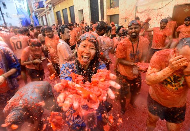 Revellers participate in the "Tomatina" annual food-battle in the Spanish eastern town of Bunol, on August 26, 2026. (Photo by Jose JORDAN / AFP)