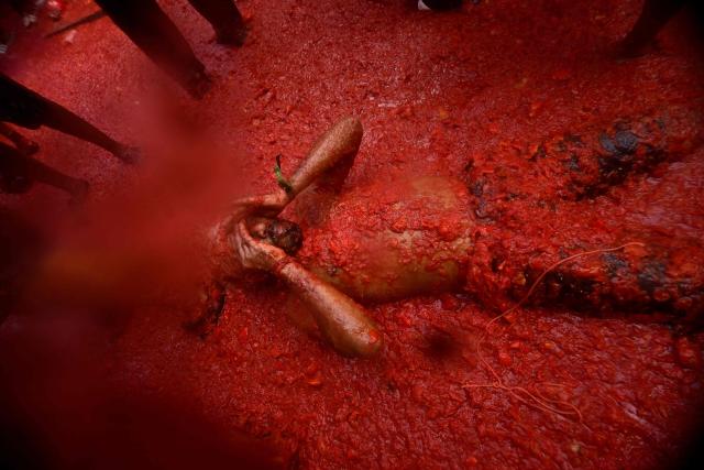 Revellers participate in the "Tomatina" annual food-battle in the Spanish eastern town of Bunol, on August 26, 2026. (Photo by Jose JORDAN / AFP)