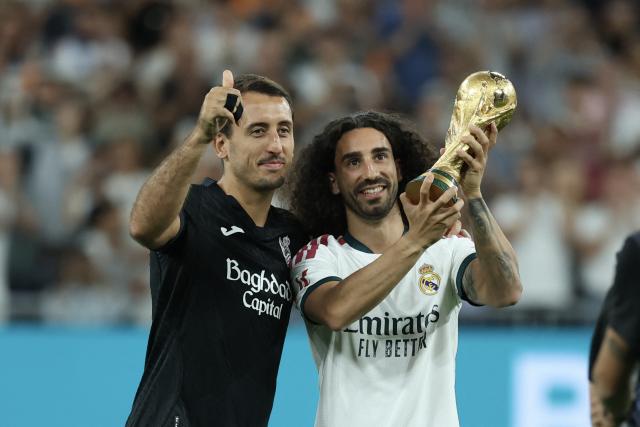 Real Sociedad's Spanish forward #10 Mikel Oiarzabal (L) and Real Madrid's Spanish defender #17 Marc Cucurella, members of Spain's natinal football team that won the World Cup earlier this year, pose together before the start of the Spanish league football match between Real Madrid CF and Real Sociedad  at Santiago Bernabeu Stadium in Madrid on August 26, 2026. (Photo by Thomas COEX / AFP)