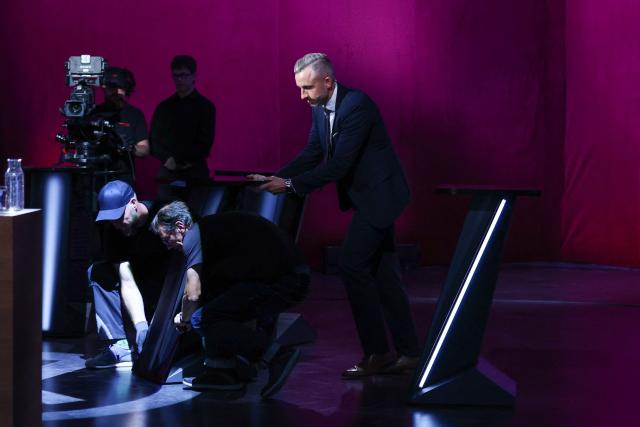 Ulrich Siegmund (R), far-right Alternative for Germany (AfD)'s main candidate in the Saxony-Anhalt state election helps studio technicians move a table prior to a head-to-head debate on MDR regional TV in the Broadcasting Center Saxony-Anhalt in Magdeburg, on August 26, 2026, ahead of the upcoming state elections. Saxony-Anhalt will go to the polls in the regional elections on September 6, 2026. (Photo by Ronny HARTMANN / AFP)