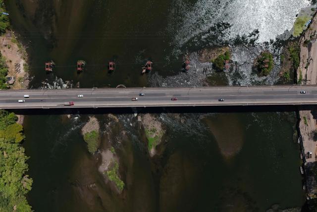 Aerial view of the Lempa River, El Salvador's main river, showing significantly reduced water levels amid a severe drought in Usulutan department, El Salvador, on August 26, 2026. The prolonged lack of rainfall, associated with the El Nino phenomenon, has sharply reduced the river's flow, worsening water shortages affecting agriculture, livestock and rural communities. El Salvador declared a nationwide red alert for meteorological and agricultural drought on August 25, 2026. (Photo by Marvin RECINOS / AFP)
