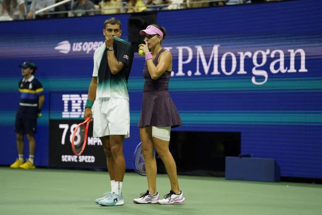 Italy's Flavio Cobolli and Switzerland's Belinda Bencic confer during their mixed doubles semi-finals tennis match against France's Gael Monfils and Ukraine's Elina Svitolina during the 2026 US Open tennis tournament at the USTA Billie Jean King National Tennis Center in New York on August 26, 2026. (Photo by TIMOTHY A. CLARY / AFP)
