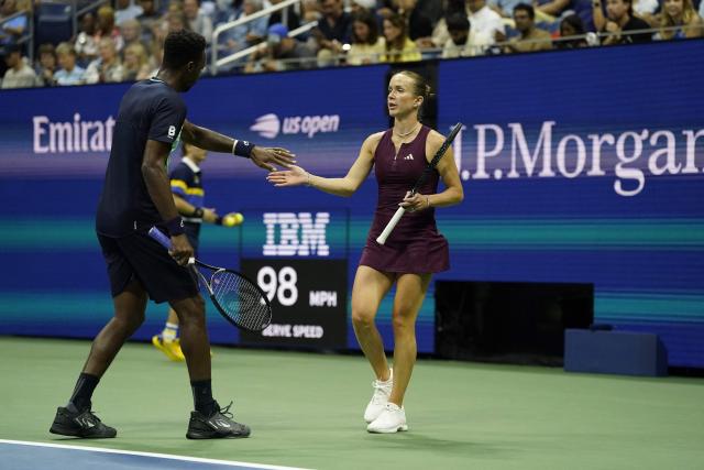 France's Gael Monfils interacts with Ukraine's Elina Svitolina during their mixed doubles semi-finals tennis match against Switzerland's Belinda Bencic and Italy's Flavio Cobolli during the 2026 US Open tennis tournament at the USTA Billie Jean King National Tennis Center in New York on August 26, 2026. (Photo by TIMOTHY A. CLARY / AFP)