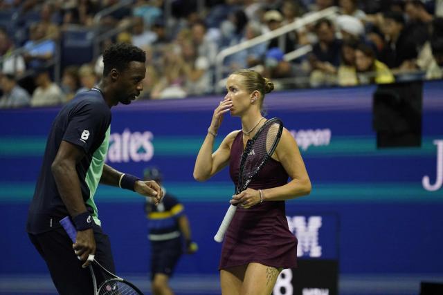 France's Gael Monfils and Ukraine's Elina Svitolina confer during their mixed doubles semi-finals tennis match against Switzerland's Belinda Bencic and Italy's Flavio Cobolli during the 2026 US Open tennis tournament at the USTA Billie Jean King National Tennis Center in New York on August 26, 2026. (Photo by TIMOTHY A. CLARY / AFP)