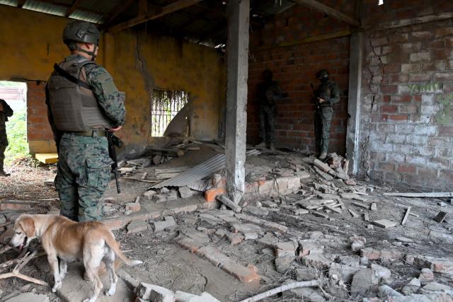 Elite members of the Ecuadorian Army stand guard inside a property during a raid in the El Porvenir neighbourhood as part of a patrol operation in Manta, Ecuador, on August 26, 2026. (Photo by ARIEL OCHOA / AFP)