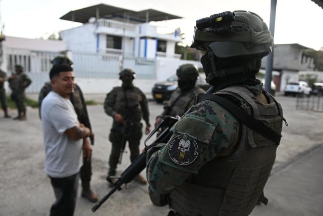 Elite members of the Ecuadorian Army stand outside a property in the El Porvenir neighbourhood during a patrol operation in Manta, Ecuador, on August 26, 2026. (Photo by ARIEL OCHOA / AFP)