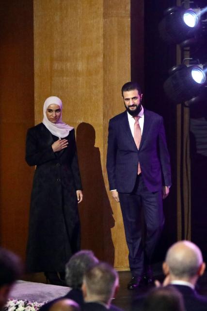 Syria's President Ahmed al-Sharaa (R) and his wife Latifa al-Droubi arrive during the inauguration ceremony of the 63rd edition of the Damascus International Fair, in the capital Damascus on August 26, 2026. (Photo by Bakr ALkasem / AFP)