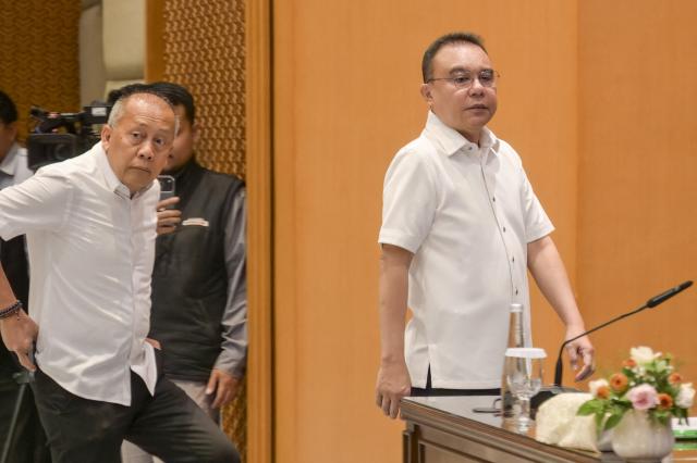 Deputy Speakers of the Indonesian House of Representatives Saan Mustofa (L) and Sufmi Dasco Ahmad (R) arrive at a meeting to receive representatives of protesters at the House of Representatives building in Jakarta on August 27, 2026, following a demonstration urging lawmakers to immediately pass an asset forfeiture law for corruptors. (Photo by BAY ISMOYO / AFP)