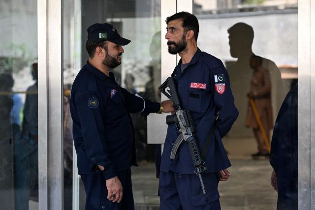 Security personnel stand at the entrance of the Mother and Child Health ward, a day after the fire at the Pakistan Institute of Medical Sciences (PIMS) Hospital in Islamabad on August 27, 2026. A fire erupted in a hospital maternity ward in Islamabad on August 26 killing 14 infants, Pakistan authorities said, blaming a faulty air conditioner for the blaze. (Photo by Aamir QURESHI / AFP)