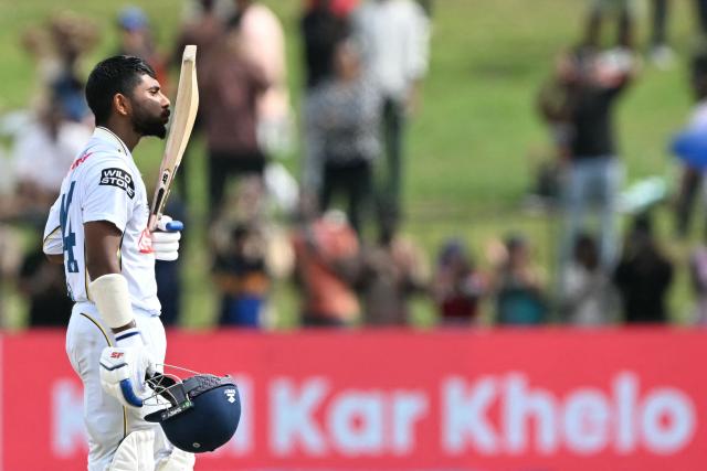 Sri Lanka's Sonal Dinusha celebrates after scoring a century (100 runs) during the fifth day of the second Test cricket match between Sri Lanka and India at the Sinhalese Sports Club Ground in Colombo on August 27, 2026. (Photo by Ishara S. KODIKARA / AFP)