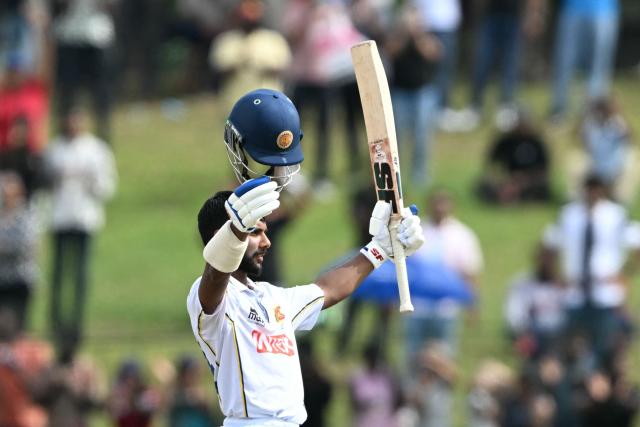 Sri Lanka's Sonal Dinusha celebrates after scoring a century (100 runs) during the fifth day of the second Test cricket match between Sri Lanka and India at the Sinhalese Sports Club Ground in Colombo on August 27, 2026. (Photo by Ishara S. KODIKARA / AFP)