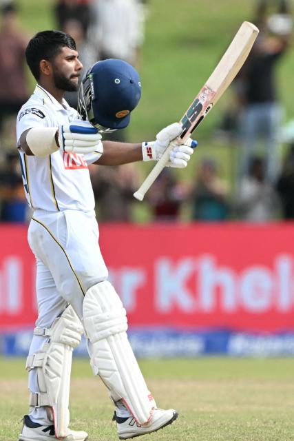 Sri Lanka's Sonal Dinusha celebrates after scoring a century (100 runs) during the fifth day of the second Test cricket match between Sri Lanka and India at the Sinhalese Sports Club Ground in Colombo on August 27, 2026. (Photo by Ishara S. KODIKARA / AFP)