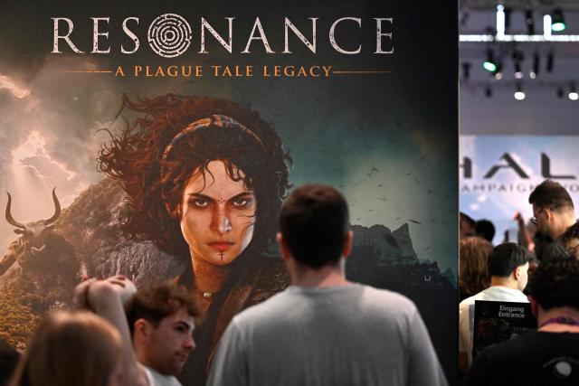 Gamers stand at the "Resonance: A Plague Tale Legacy" video games booth of Asobo Studio during the Gamescom video games trade fair on the fair grounds in Cologne, western Germany, on August 27, 2026. The 2026 edition of the vast Gamescom trade fair in Cologne, Germany, had its opening night on August 25, 2025 and will be running from August 26 to 30, 2026. (Photo by Ina FASSBENDER / AFP)