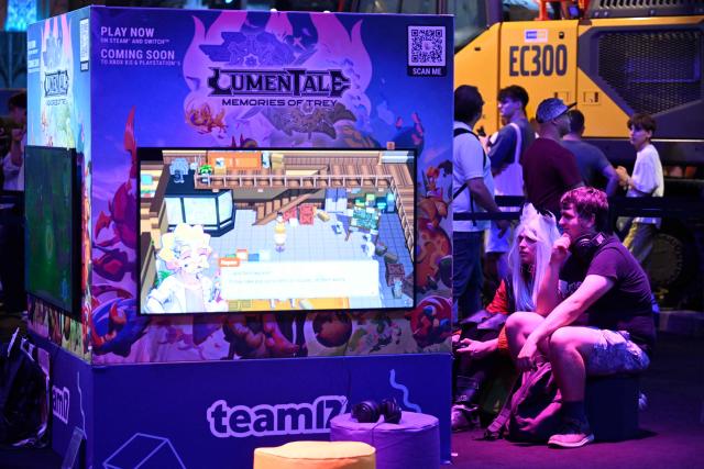 Gamers play video games during the Gamescom video games trade fair on the fair grounds in Cologne, western Germany, on August 27, 2026. The 2026 edition of the vast Gamescom trade fair in Cologne, Germany, had its opening night on August 25, 2025 and will be running from August 26 to 30, 2026. (Photo by Ina FASSBENDER / AFP)