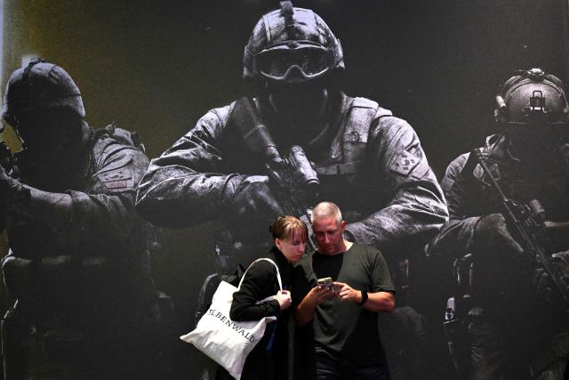 Visitors stand in front of an adverstisement for the "Call of Duty 4: Modern Warfare" video game of Infinity Ward during the Gamescom video games trade fair on the fair grounds in Cologne, western Germany, on August 27, 2026. The 2026 edition of the vast Gamescom trade fair in Cologne, Germany, had its opening night on August 25, 2025 and will be running from August 26 to 30, 2026. (Photo by Ina FASSBENDER / AFP)