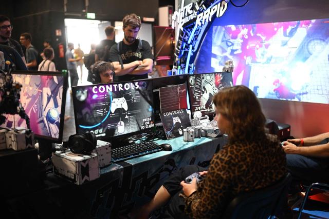A gamer plays an Indie video game at the Gamescom video games trade fair on the fair grounds in Cologne, western Germany, on August 27, 2026. The 2026 edition of the vast Gamescom trade fair in Cologne, Germany will be running from August 26 to 30, 2026. (Photo by Ina FASSBENDER / AFP)