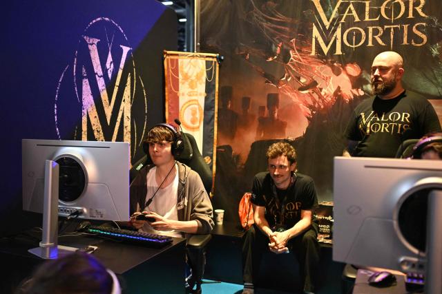Gamers play the "Valor Mortis" video game at the Indie game area during the Gamescom video games trade fair on the fair grounds in Cologne, western Germany, on August 27, 2026. The 2026 edition of the vast Gamescom trade fair in Cologne, Germany, had its opening night on August 25, 2025 and will be running from August 26 to 30, 2026. (Photo by Ina FASSBENDER / AFP)