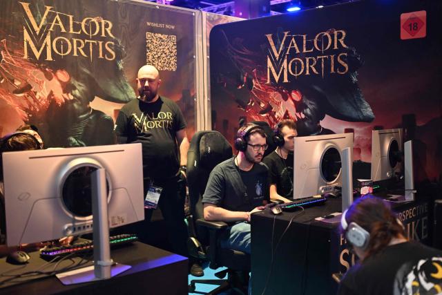 Gamers play the "Valor Mortis" video game at the Indie game area during the Gamescom video games trade fair on the fair grounds in Cologne, western Germany, on August 27, 2026. The 2026 edition of the vast Gamescom trade fair in Cologne, Germany, had its opening night on August 25, 2025 and will be running from August 26 to 30, 2026. (Photo by Ina FASSBENDER / AFP)