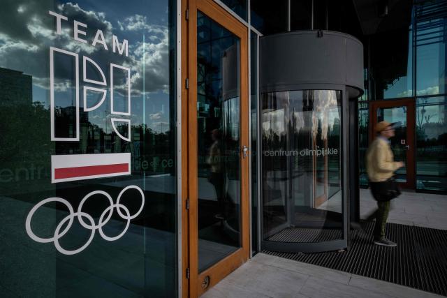 A man leaves the building of the Olympic Centre in Warsaw, where the Poland's Olympic Committee has its headquarters, on August 27, 2026. Police on August 27, 2026 arrested the head of the Polish Olympic Committee on suspicion that he took bribes from a crypto trader in return for sponsorship deals, officials said. (Photo by Wojtek RADWANSKI / AFP)