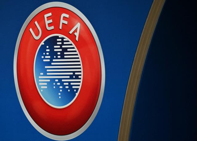 (FILES) This photograph shows the UEFA logo displayed at the end of the 2025-2026 UEFA Europa League round of 16, quarter-final and semi-final draw at the House of European Football in Nyon, western Switzerland on February 27, 2026. UEFA is preparing a complaint under Swiss law against FIFA president Gianni Infantino for “unfair management”, following his failed plan to open up the World Cup to private investors, it was revealed on August 27, 2026 by a source close to the matter. (Photo by Harold CUNNINGHAM / AFP)
