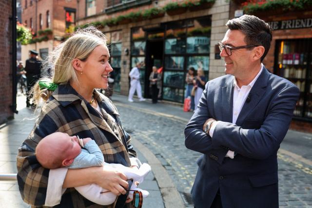 Britain's Prime Minister Andy Burnham speaks to a person during a to Belfast, Northern Ireland on August 27, 2026, where he met people to discuss the cost of living. (Photo by Cathal McNaughton / POOL / AFP)