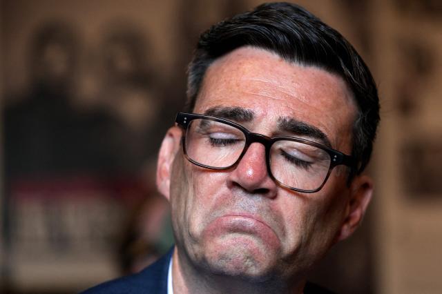 Britain's Prime Minister Andy Burnham reacts during a visit to the The Oh Yeah centre in Belfast, Northern Ireland on August 27, 2026, where he met young people to discuss the cost of living. (Photo by Cathal McNaughton / POOL / AFP)