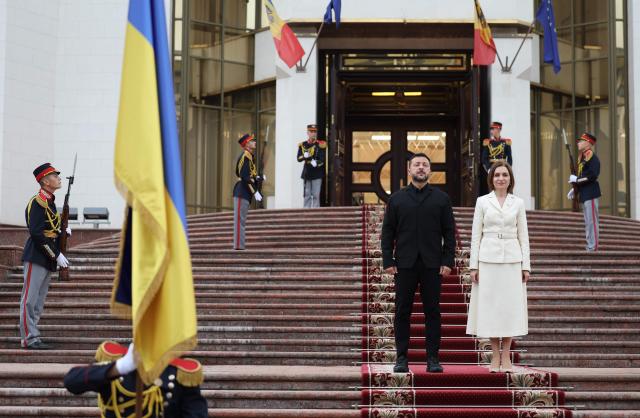 TOPSHOT - Moldovan President Maia Sandu (R) welcomes Ukrainian President Volodymyr Zelensky (L) upon his arrival in Chisinau at Moldovan Presidency headquarters on August 27, 2026, to attend official ceremonies marking Moldova’s National Day. Moldova celebrates its National Day on August 27, commemorating the adoption of the Declaration of Independence from the Soviet Union in 1991. Zelensky joined Moldovan leaders and foreign dignitaries for events dedicated to the anniversary of independence. (Photo by Elena COVALENCO / AFP)
