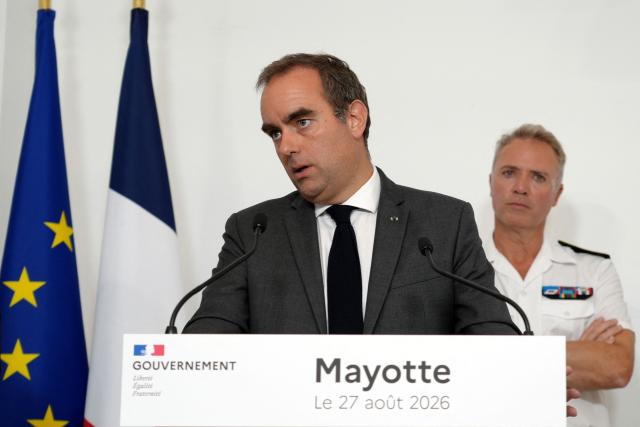 France's Prime Minister Sebastien Lecornu (L), flanked by Mayotte’s prefect Frederic Poisot, speaks during a press coneference in Pamandzi, on the French Indian Ocean territory of Mayotte, on August 27, 2026. (Photo by Marine Gachet / AFP)