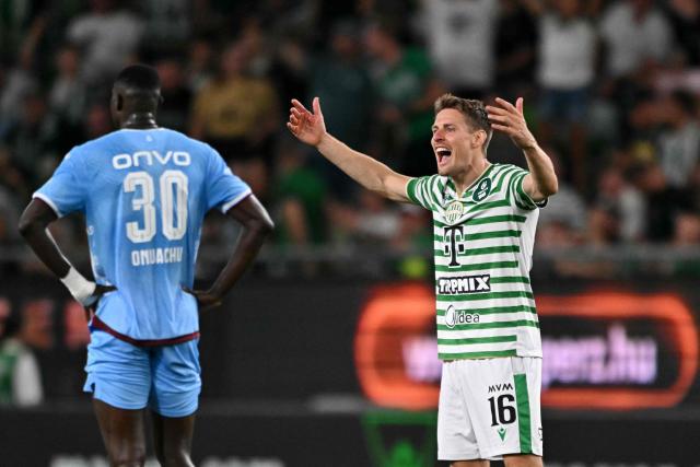 Ferencvaros' Norwegian midfielder #16 Kristoffer Zachariassen (R) celebrates after Ferencvaros' opening goal during the UEFA Europa League second leg playoff football match between Ferencvaros and Trabzonspor in Budapest on August 27, 2026. (Photo by Attila KISBENEDEK / AFP)